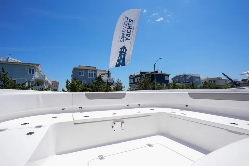 Slide: The Image of 2024 Caymas 281 HB boat deck with Sandy Hook Yachts flag in background. - 25