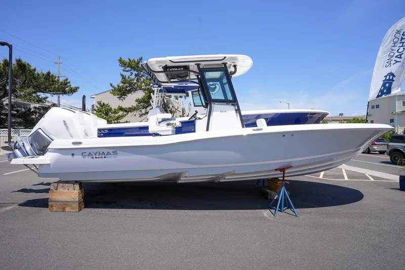 Slide: The Image of 2024 Caymas 281 HB boat on display in a parking lot. - 8