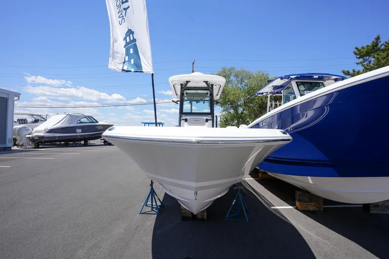 Slide: The Image of 2024 Caymas 281 HB boat displayed outdoors on a sunny day. - 9