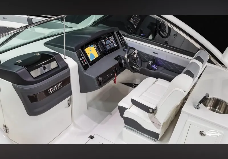 Slide: The Image of 2024 Chaparral 310 OSX boat cockpit with modern navigation system and luxurious seating. - 13