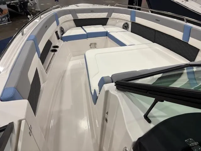 Slide: The Image of 2024 Chaparral 310 OSX boat interior with spacious seating and modern design. - 4