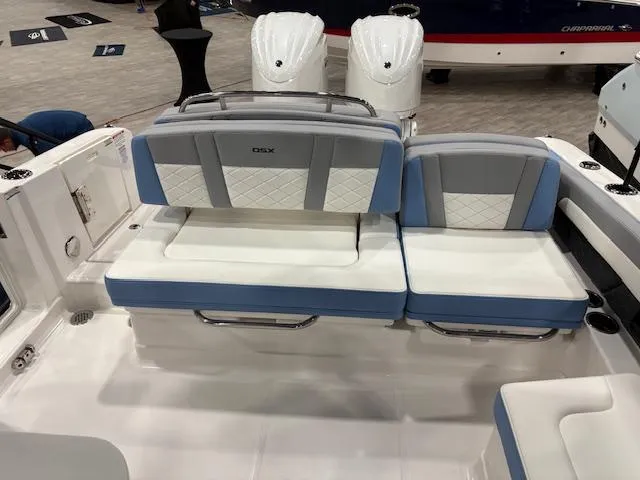 Slide: The Image of 2024 Chaparral 310 OSX boat interior with cushioned seating and modern design. - 5