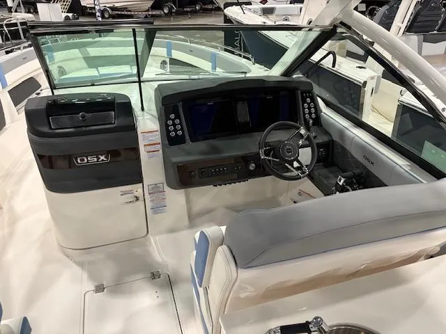 Slide: The Image of 2024 Chaparral 310 OSX boat cockpit with modern dashboard and steering wheel. - 6