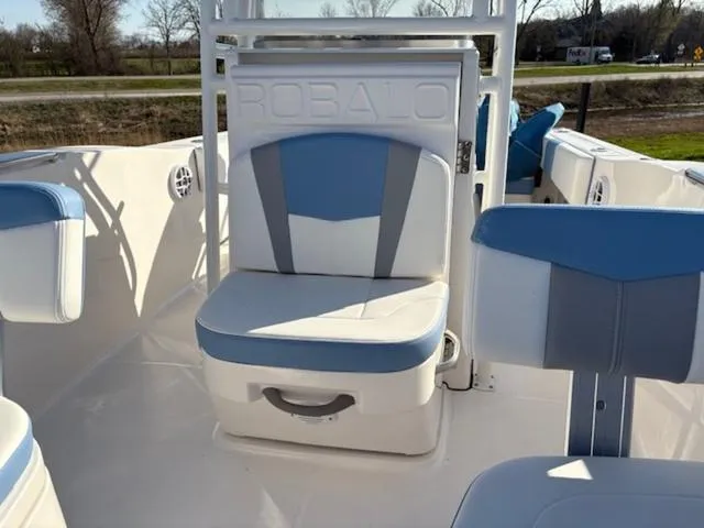 Slide: The Image of 2024 Robalo R202EX boat interior with blue and white seating. - 10