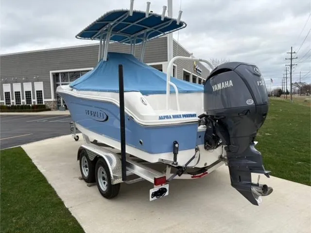 Slide: The Image of 2024 Robalo R202EX boat with Yamaha engine on trailer, parked outdoors. - 12