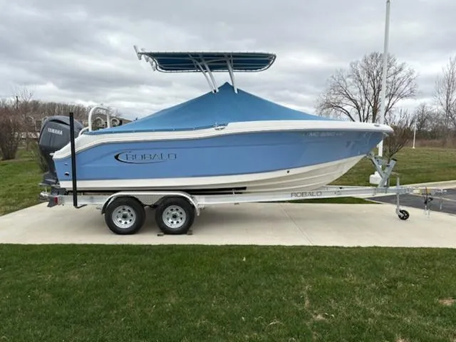 Slide: The Image of 2024 Robalo R202EX boat with Yamaha engine on trailer, parked outdoors. - 3