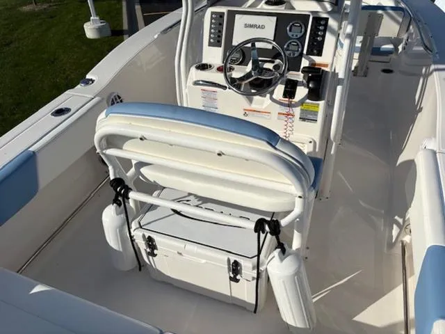 Slide: The Image of 2024 Robalo R202EX boat interior with steering console and seating. - 8