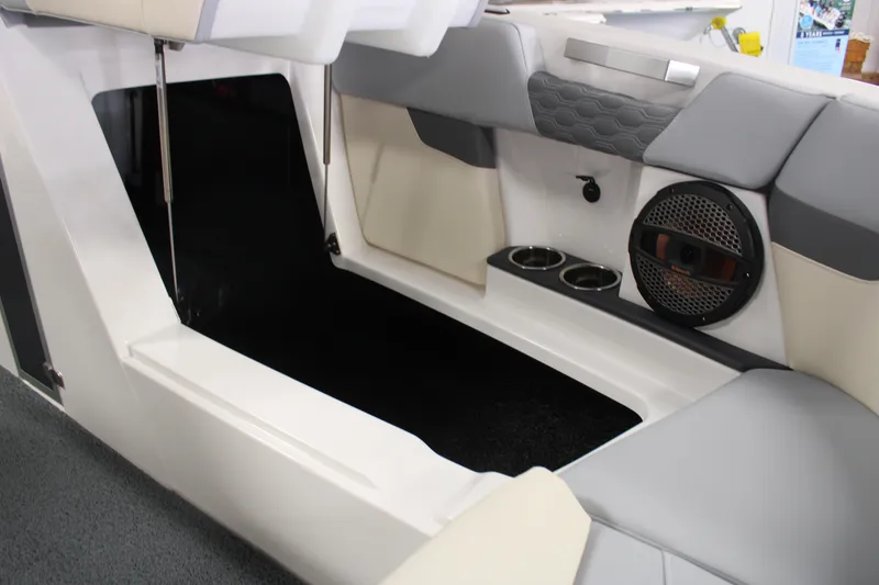 Slide: The Image of 2024 MasterCraft XT24 boat interior with seating, cup holders, and speaker system. - 10