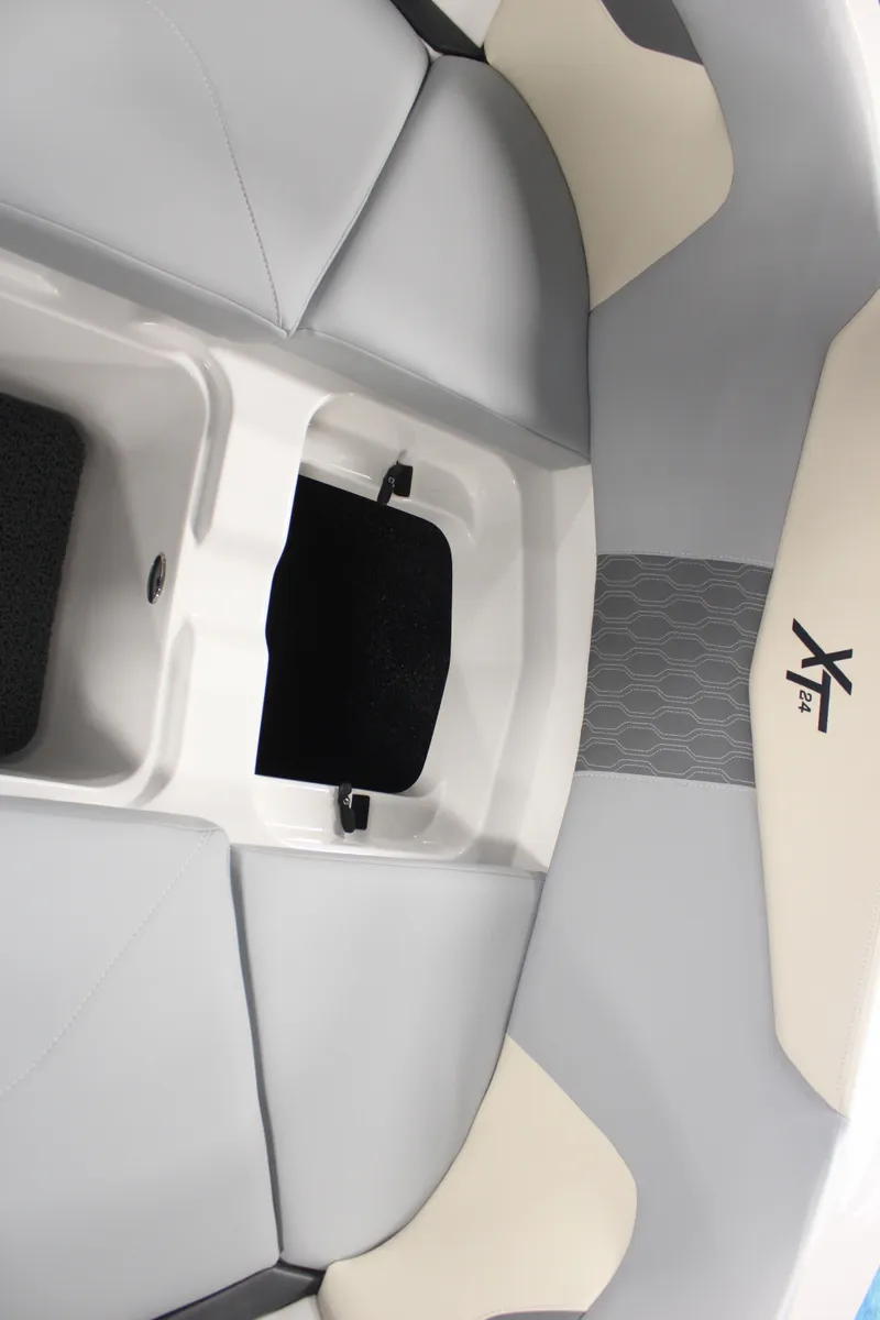 Slide: The Image of 2024 MasterCraft XT24 boat interior with sleek gray and white seating design. - 11