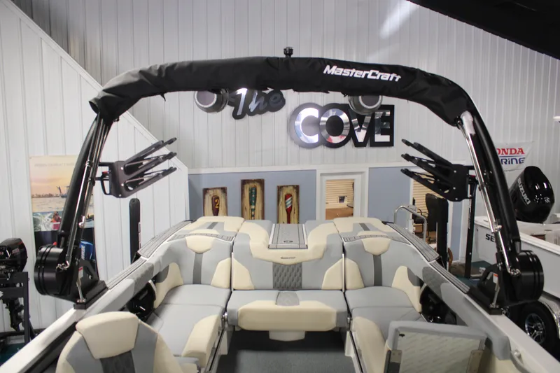 Slide: The Image of 2024 MasterCraft XT24 boat interior with seating and wakeboard racks, displayed indoors. - 18