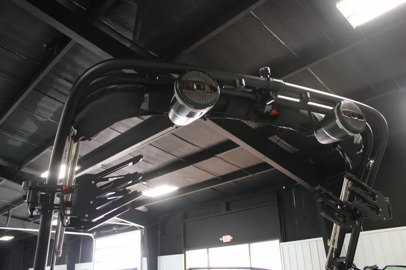 Slide: The Image of 2024 MasterCraft XT24 boat tower with speakers in a showroom setting. - 19