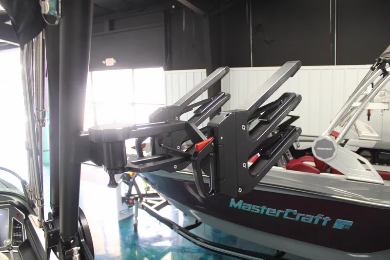 Slide: The Image of 2024 MasterCraft XT24 boat with wakeboard rack in showroom. - 20