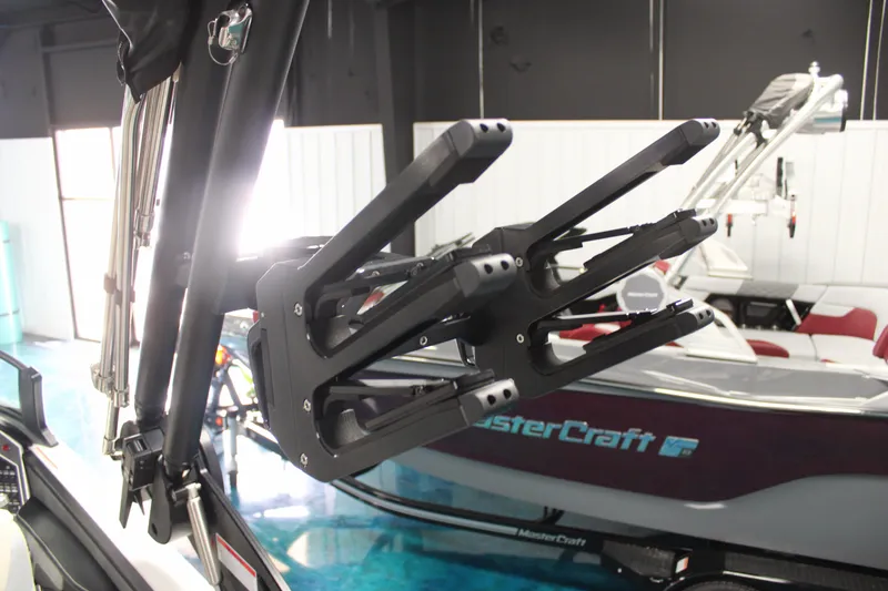 Slide: The Image of 2024 MasterCraft XT24 boat with advanced wakeboard rack in showroom. - 21