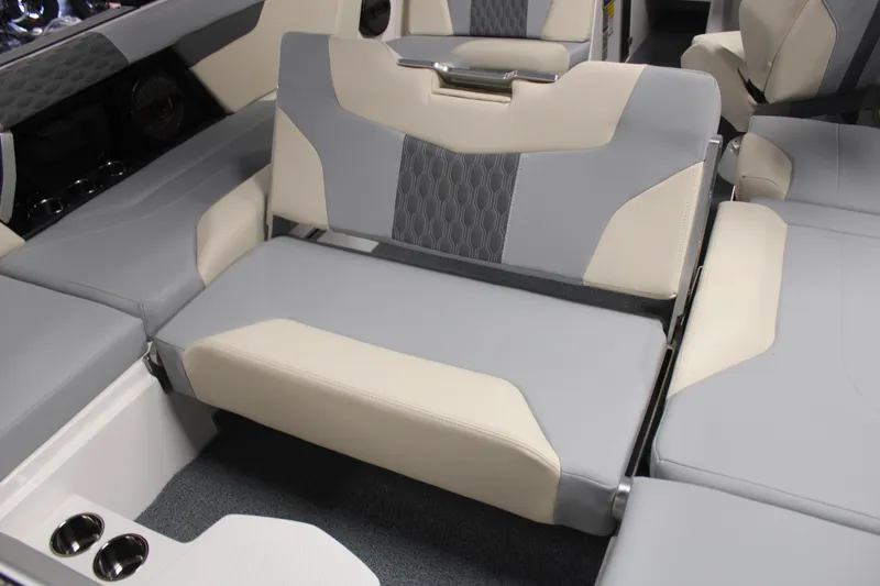 Slide: The Image of 2024 MasterCraft XT24 boat interior with gray and cream seating, featuring modern design and comfort. - 24