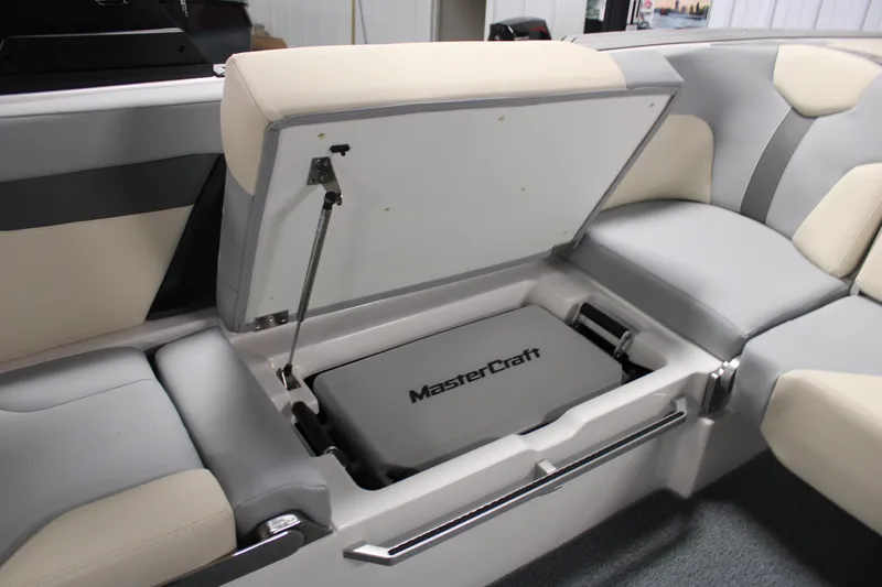 Slide: The Image of 2024 MasterCraft XT24 boat interior with open storage compartment, showcasing sleek design and functionality. - 26