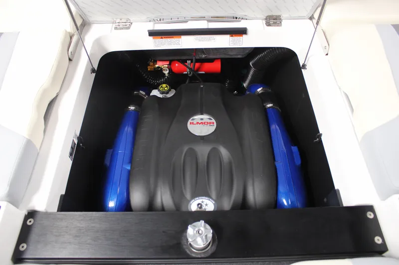 Slide: The Image of 2024 MasterCraft XT24 engine compartment with Ilmor engine, featuring blue accents and a sleek design. - 27