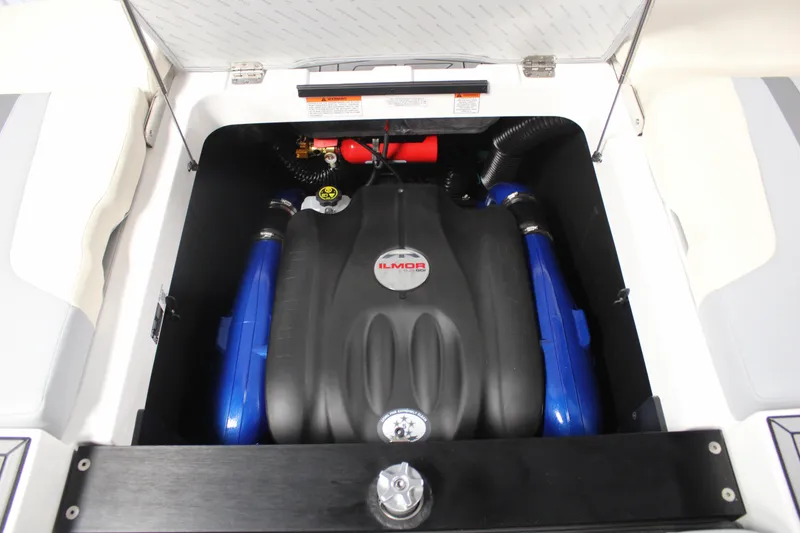 Slide: The Image of 2024 MasterCraft XT24 engine compartment with Ilmor engine, featuring blue accents. - 28