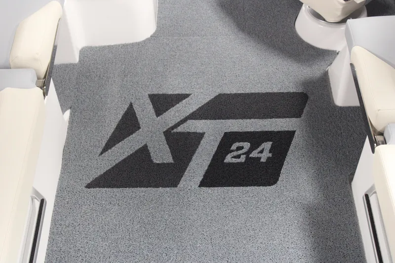 Slide: The Image of 2024 MasterCraft XT24 boat interior with logo on gray carpet. - 34