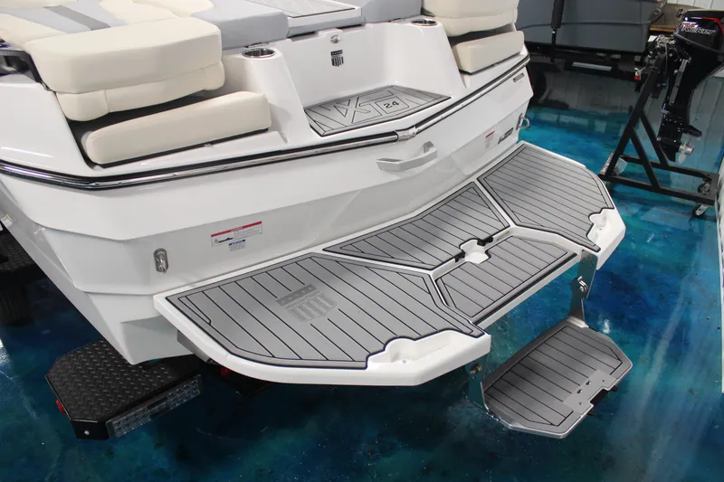 Slide: The Image of 2024 MasterCraft XT24 boat with sleek swim platform and cushioned seating. - 4