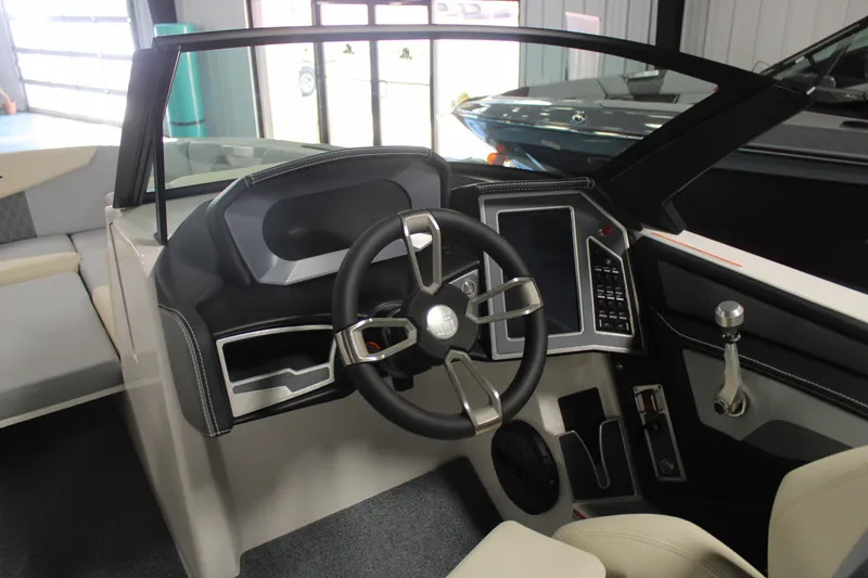 Slide: The Image of 2024 MasterCraft XT24 boat interior with modern steering wheel and dashboard controls. - 7