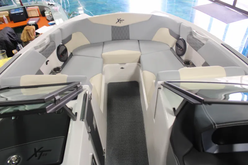 Slide: The Image of 2024 MasterCraft XT24 boat interior with spacious seating and modern design. - 8
