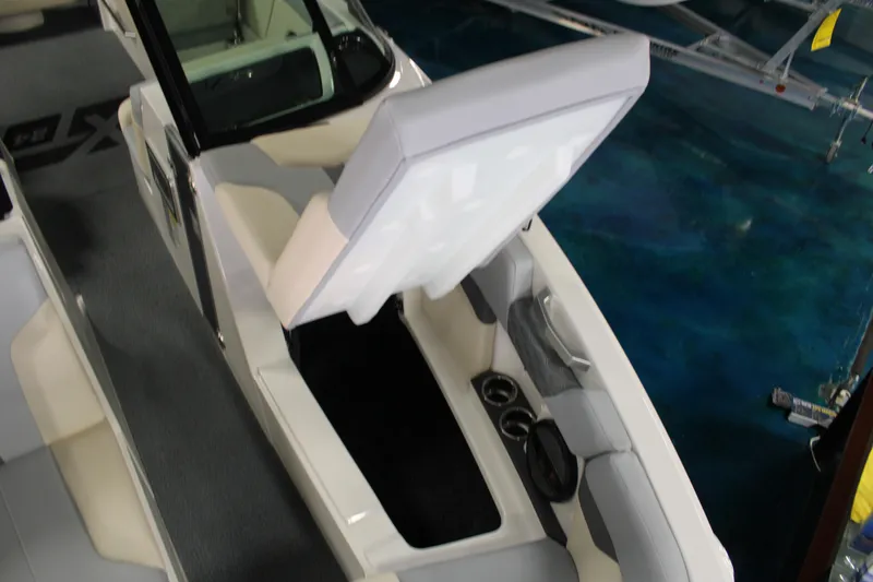 Slide: The Image of 2024 MasterCraft XT24 boat interior with open storage compartment and seating. - 9