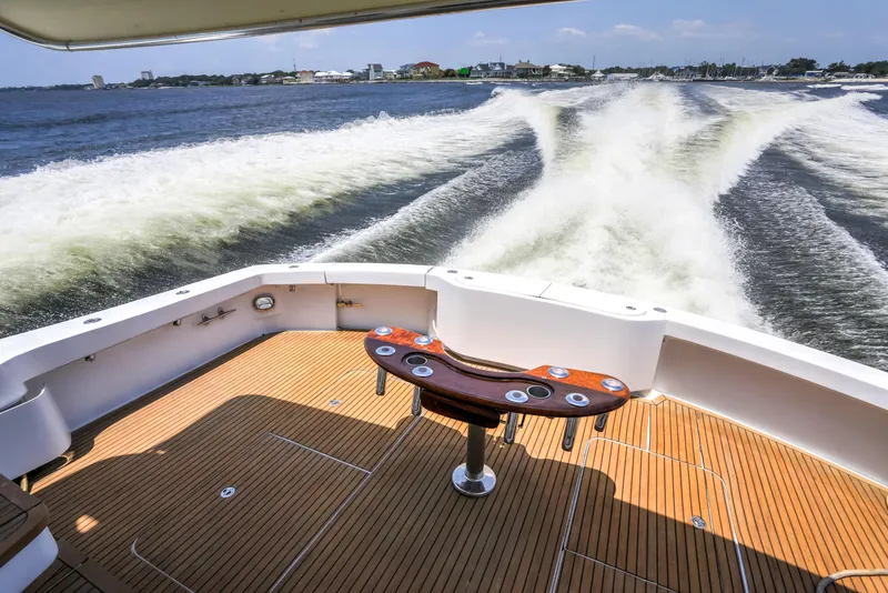 Slide: The Image of 2007 Hatteras 68 Convertible yacht cruising, view from deck with wake trails. - 11