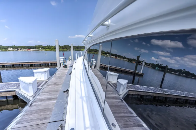 Slide: The Image of 2007 Hatteras 68 Convertible yacht docked, reflecting serene waterfront scenery. - 15