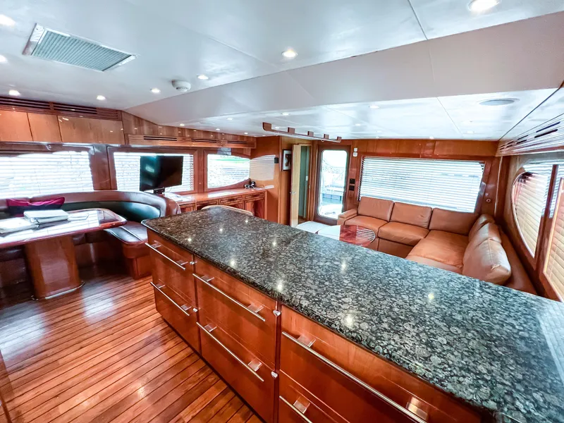 Slide: The Image of Luxurious interior of 2007 Hatteras 68 Convertible yacht with granite countertops and wooden flooring. - 17