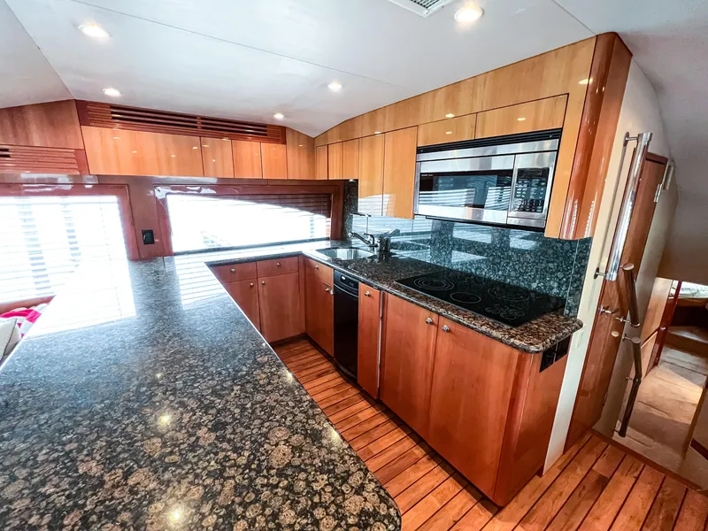 Slide: The Image of Luxurious kitchen interior of 2007 Hatteras 68 Convertible yacht with granite countertops. - 18
