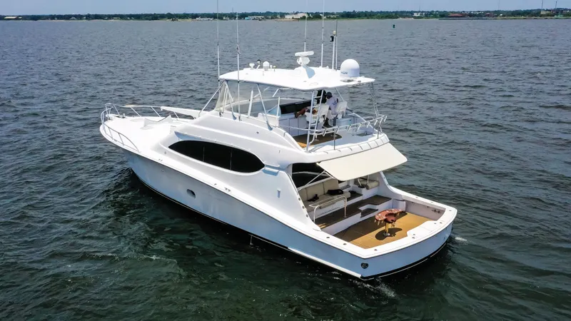 Slide: The Image of 2007 Hatteras 68 Convertible yacht cruising on open water. - 2