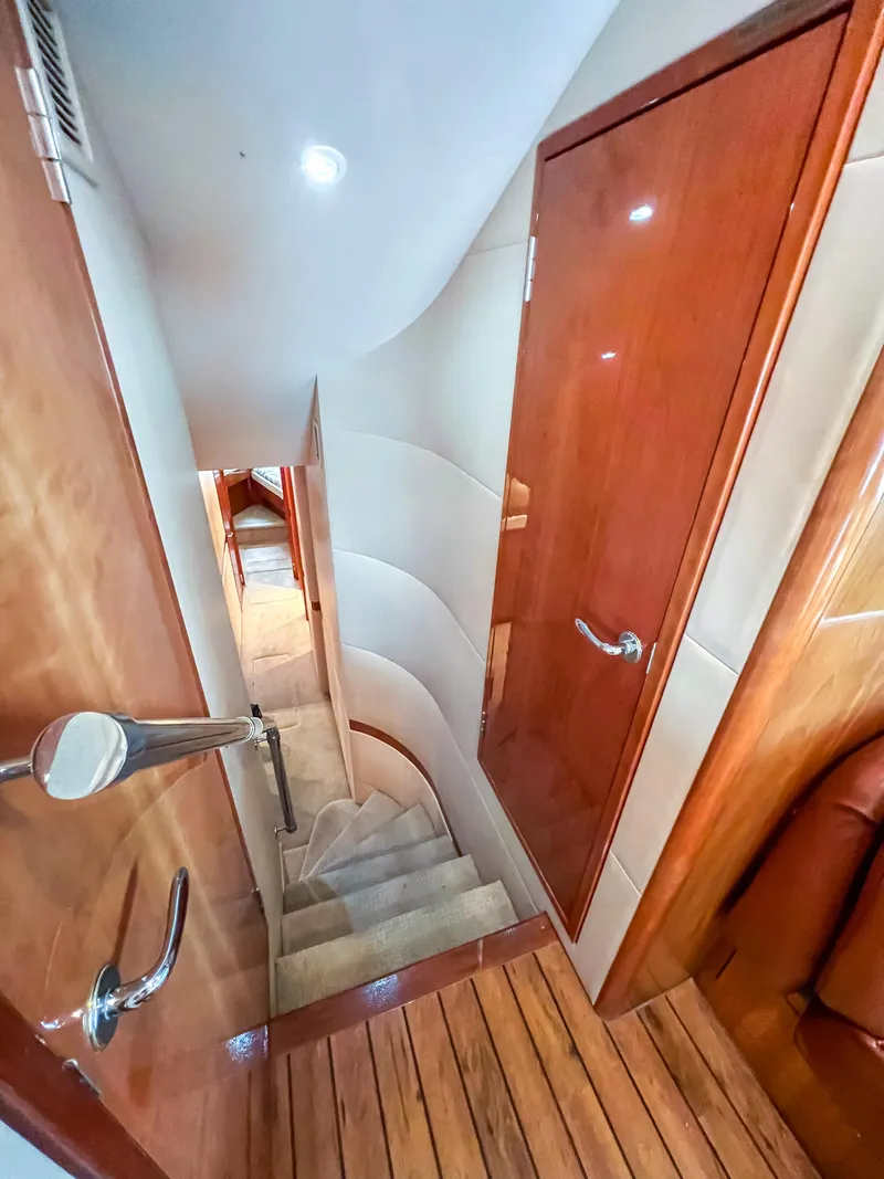 Slide: The Image of Interior view of 2007 Hatteras 68 Convertible yacht, featuring wooden stairs and doors. - 21