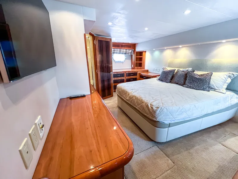 Slide: The Image of Luxurious bedroom interior of 2007 Hatteras 68 Convertible yacht with modern furnishings. - 24
