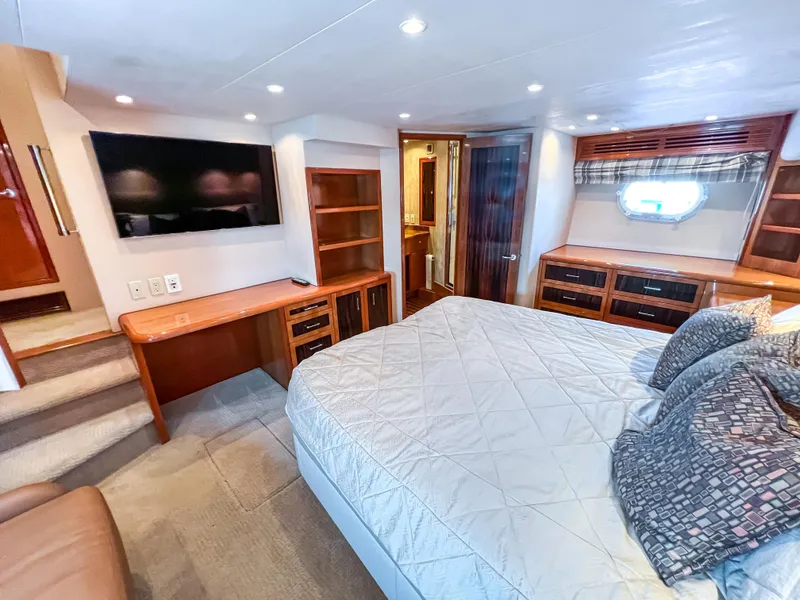 Slide: The Image of Luxurious bedroom interior of 2007 Hatteras 68 Convertible yacht with modern amenities. - 25