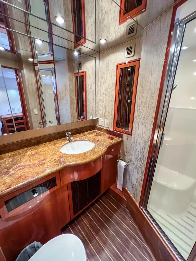 Slide: The Image of Luxurious bathroom in 2007 Hatteras 68 Convertible yacht with elegant wood and marble finishes. - 27