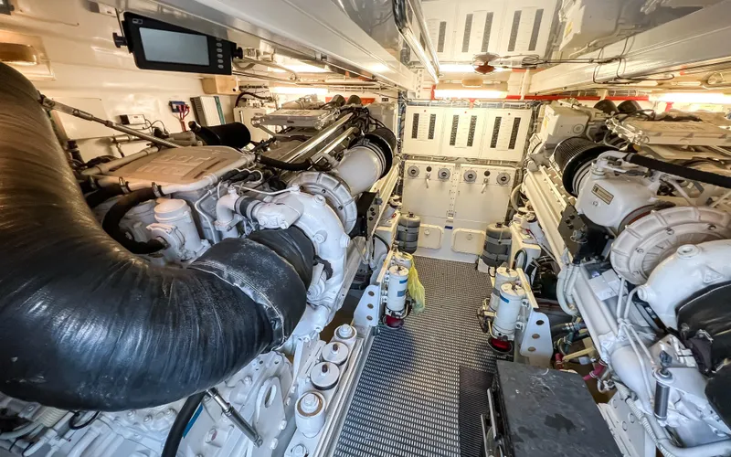 Slide: The Image of Engine room of 2007 Hatteras 68 Convertible yacht, showcasing dual engines and mechanical systems. - 33