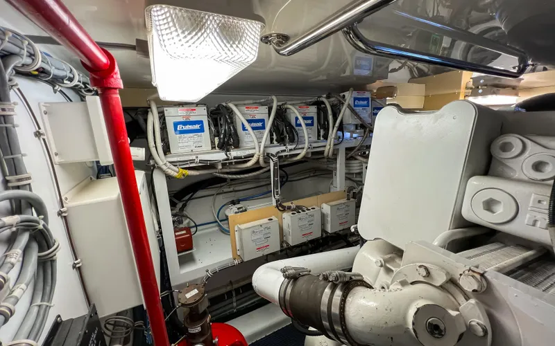 Slide: The Image of Engine room of 2007 Hatteras 68 Convertible yacht, showcasing mechanical components and wiring. - 36