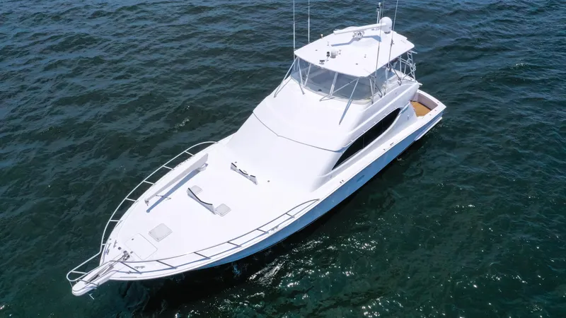 Slide: The Image of 2007 Hatteras 68 Convertible yacht cruising on open water. - 4