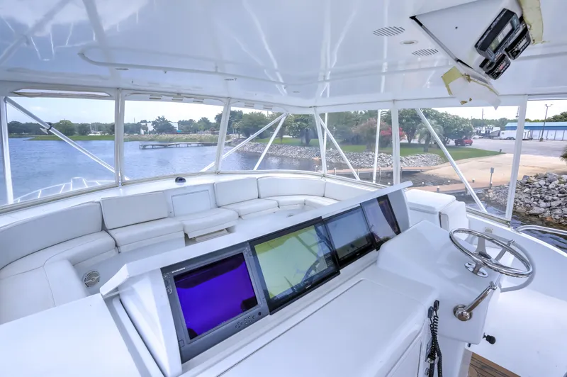 Slide: The Image of 2007 Hatteras 68 Convertible yacht helm with panoramic view and advanced navigation screens. - 8