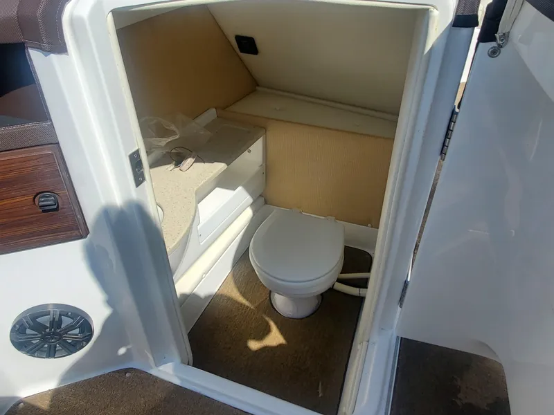 Slide: The Image of 2016 Cobalt R5 boat interior bathroom with toilet and storage space. - 27