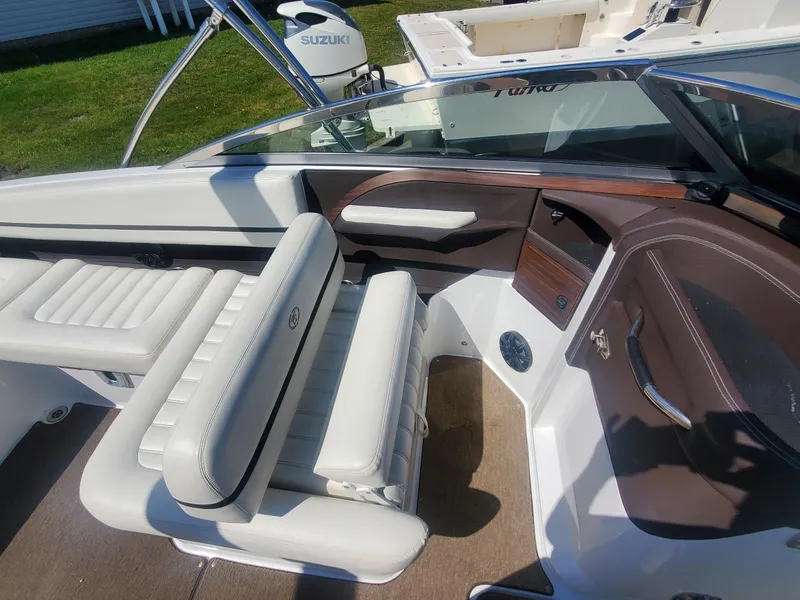 Slide: The Image of 2016 Cobalt R5 boat interior with white leather seats and brown accents. - 28