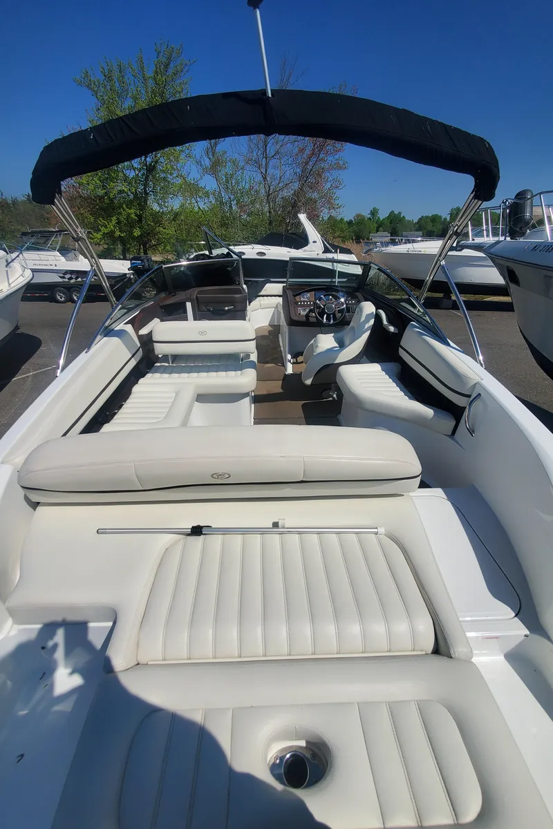 Slide: The Image of 2016 Cobalt R5 boat with white leather seating and black canopy. - 37
