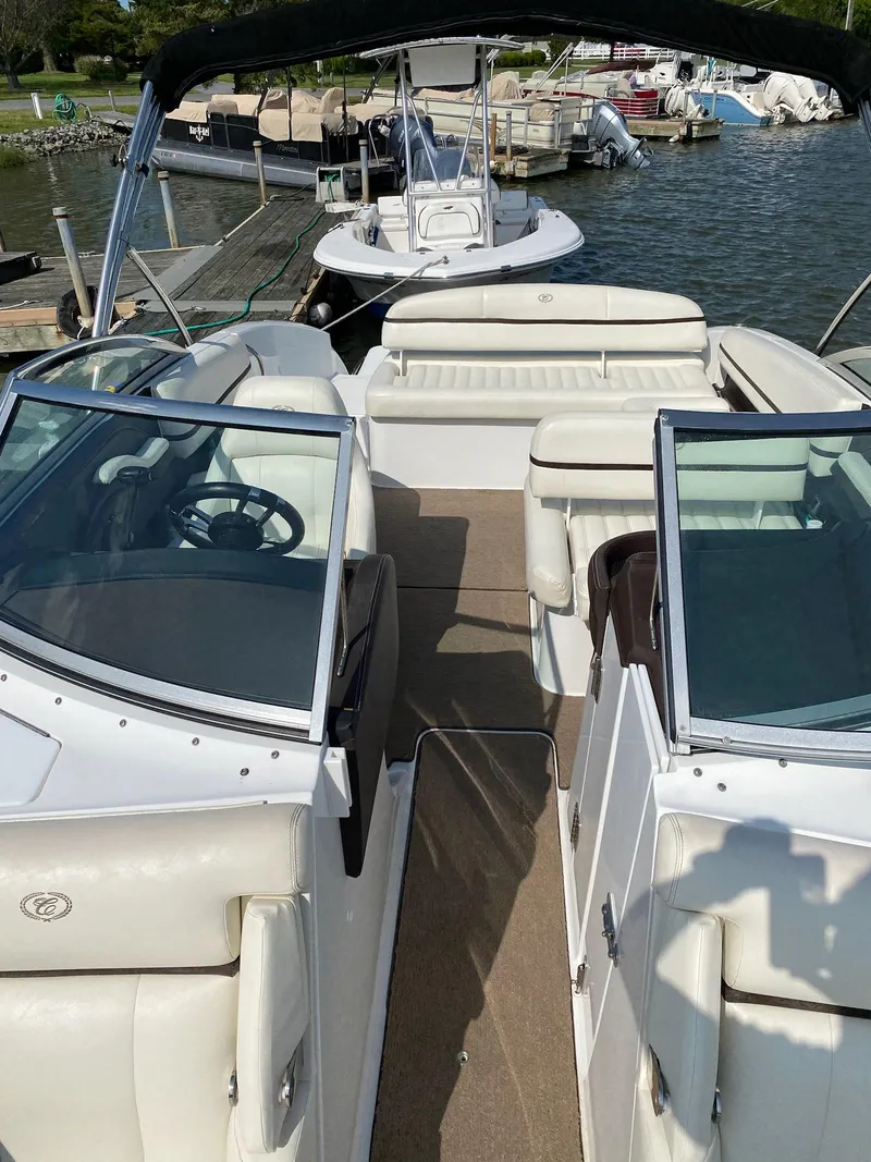 Slide: The Image of 2016 Cobalt R5 boat with white leather seating docked on the water. - 4