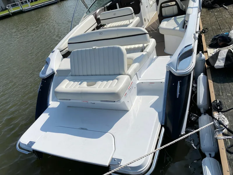 Slide: The Image of 2016 Cobalt R5 boat interior with white leather seats, docked near waterfront homes. - 6