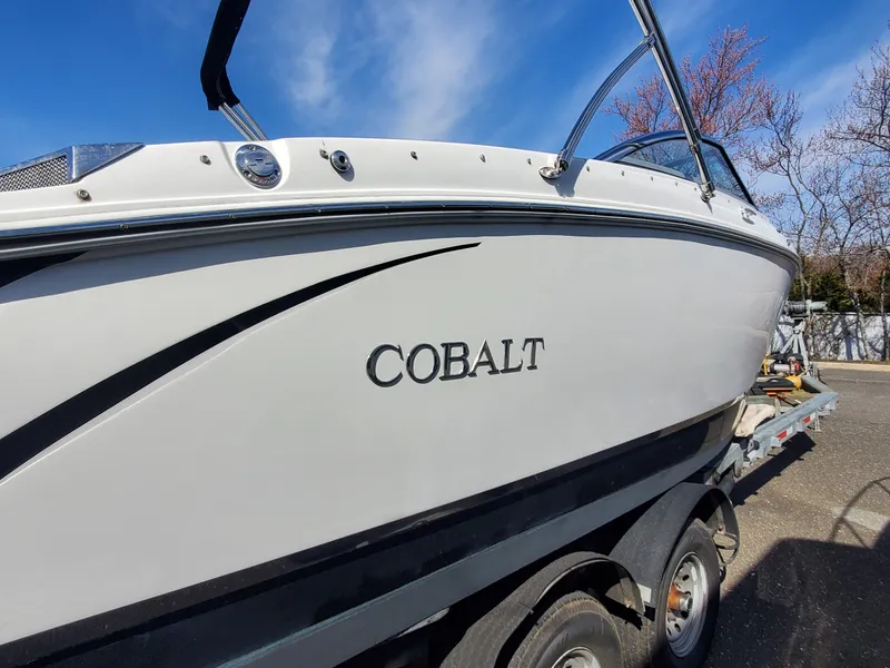 Slide: The Image of 2016 Cobalt R5 boat docked, featuring spacious seating and swim platform. - 7