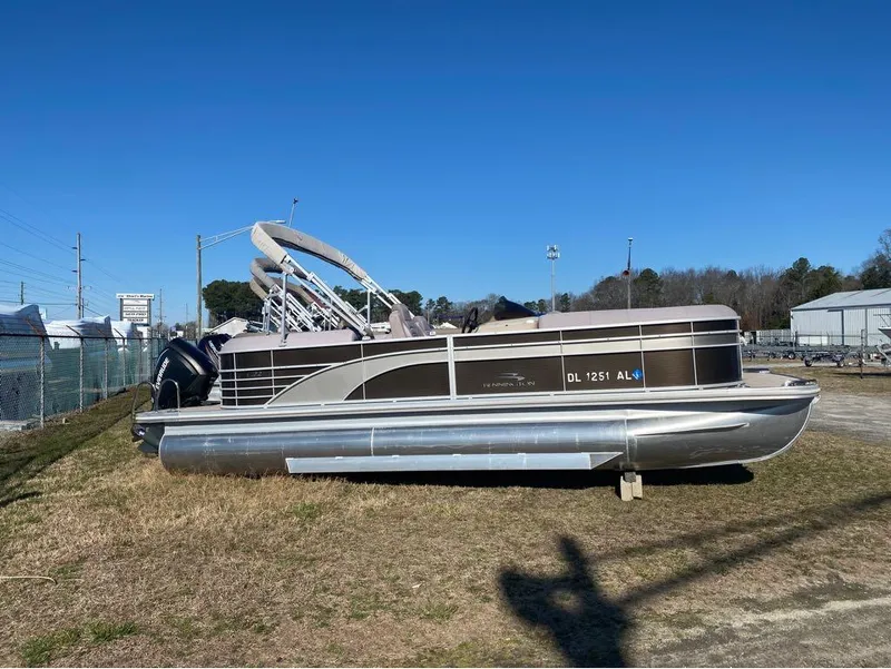 Slide: The Image of 2017 Bennington 22 GSR pontoon boat on dry land under clear blue sky. - 1