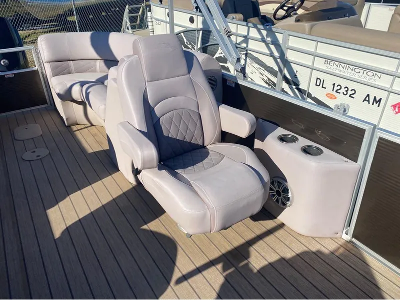 Slide: The Image of 2017 Bennington 22 GSR boat interior with plush seating and cup holders. - 9