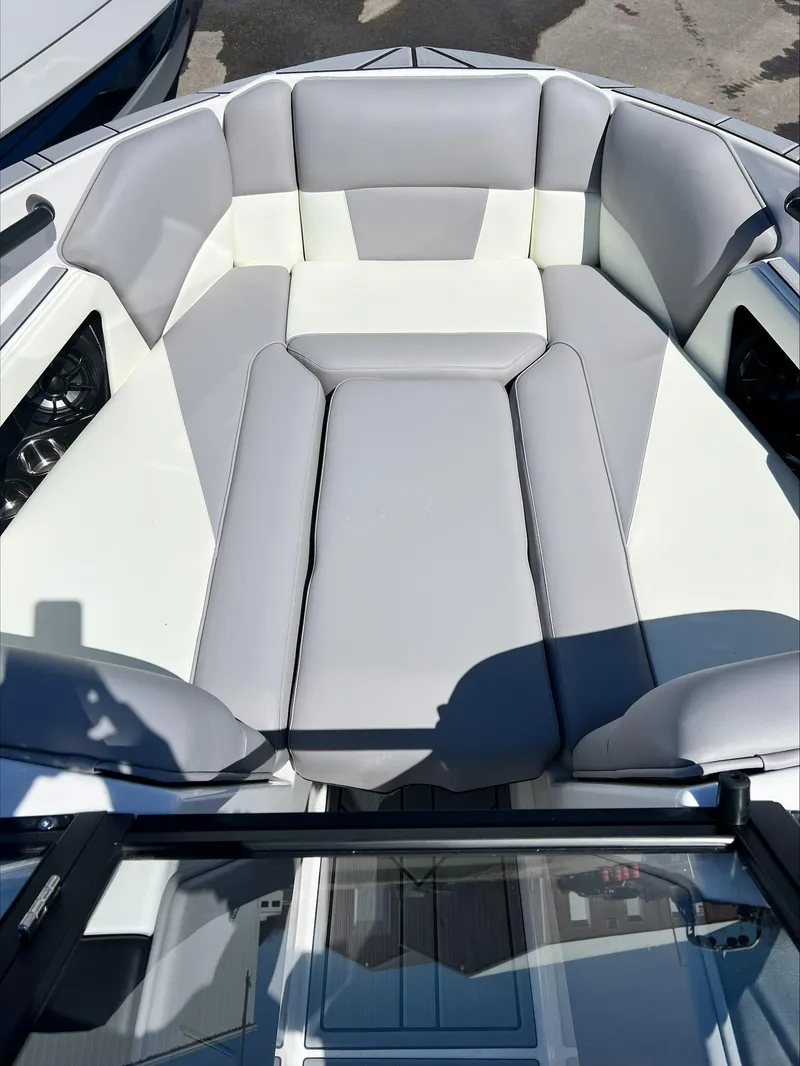 Slide: The Image of 2024 Moomba Craz boat interior with gray and white cushioned seating. - 15