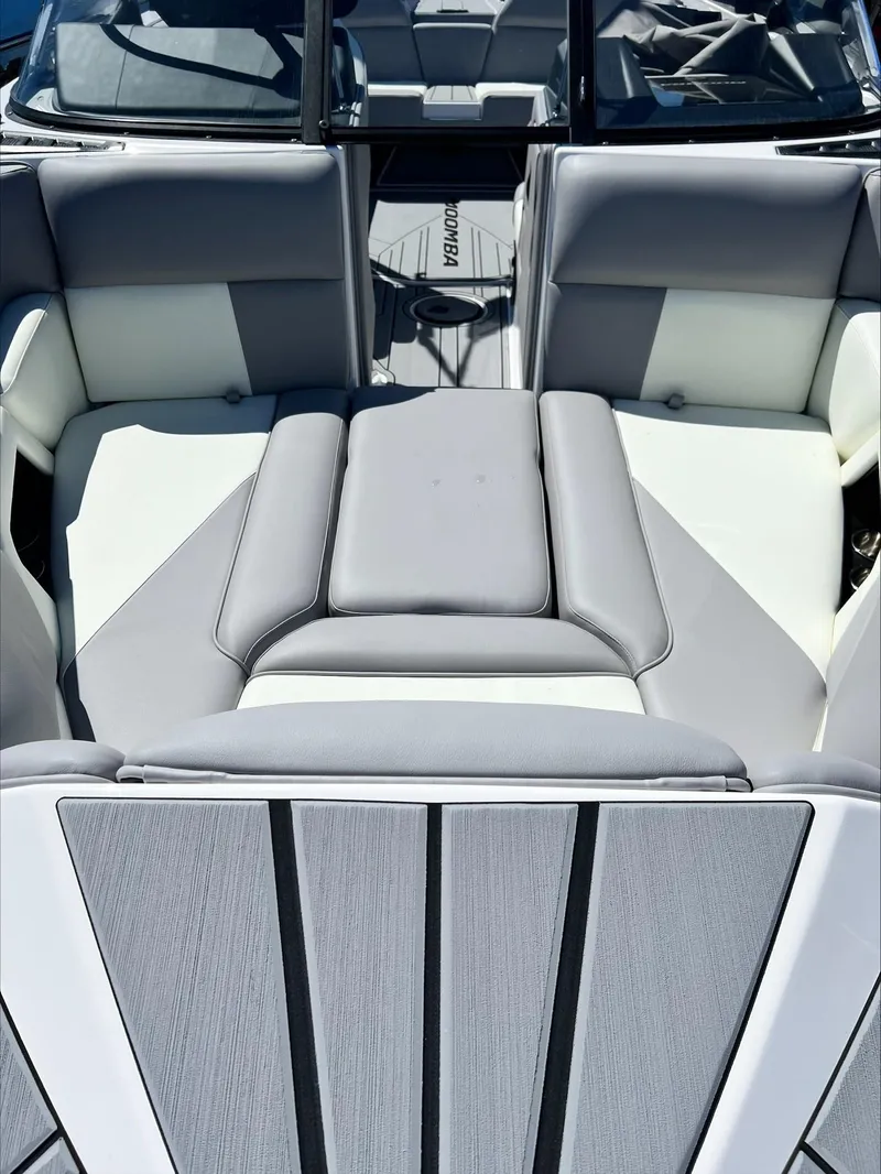 Slide: The Image of 2024 Moomba Craz boat interior with gray and white seating. - 16