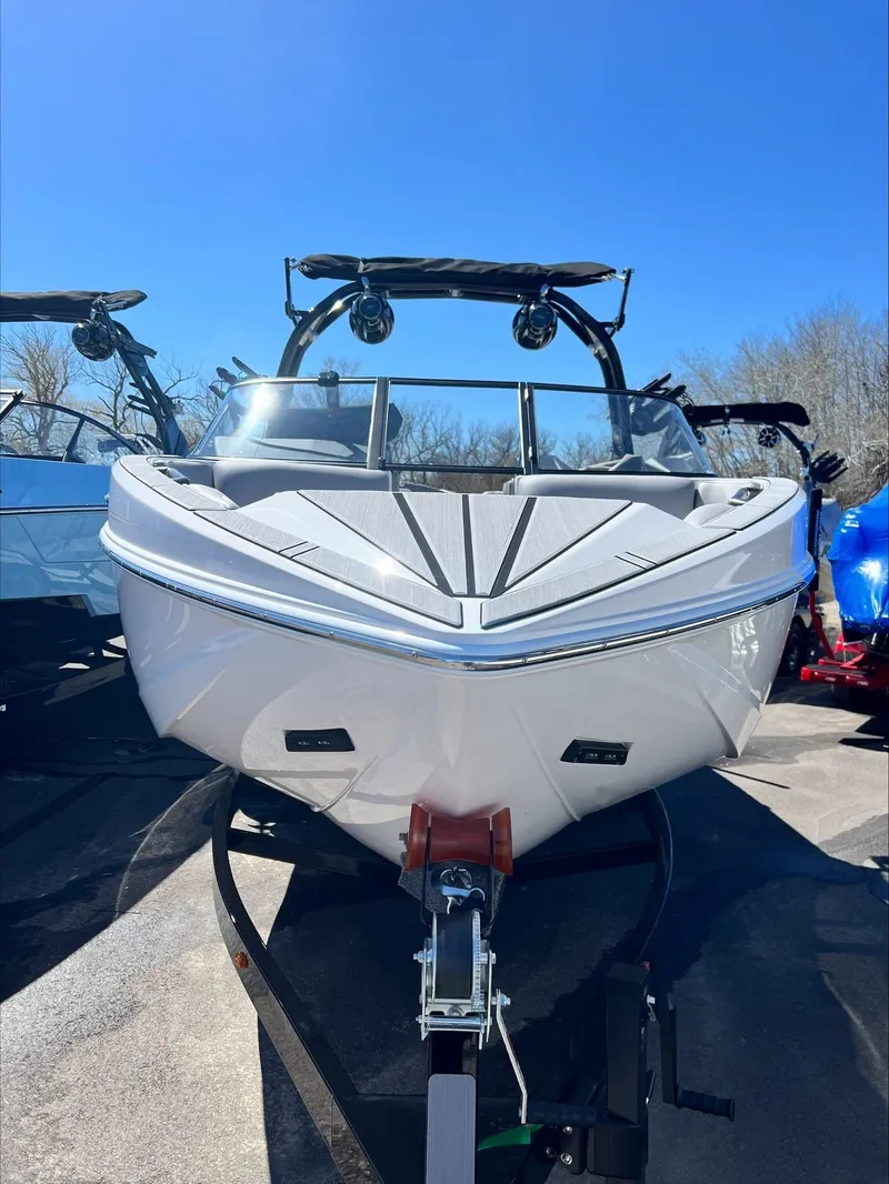 Slide: The Image of 2024 Moomba Craz boat on trailer under clear blue sky. - 17